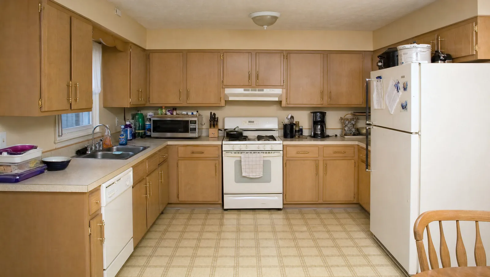 Worn builder-grade Renton kitchen before remodel — maple cabinets and laminate counters